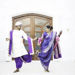 A fun and energetic dance pose, capturing the couple's joyful and playful spirit.