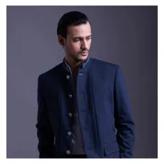 A modern take on the bandhgala in a deep navy blue. The asymmetrical button placket and structured collar offer a clean, minimalist interpretation of a classic Indian garment.