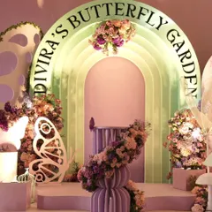 For a truly magical celebration, I designed "Divira's Butterfly Garden." This luxury decor features a stunning pastel pink and mint green arched backdrop, illuminated lettering, and is overflowing with fresh flowers and elegant butterfly cutouts, creating a fairytale setting for a special birthday girl.