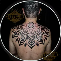 Large back pieces are a journey, and this finished geometric mandala is a testament to that process. I designed this to fit the client's entire upper back, using bold, solid blackwork to create a powerful and balanced piece that symbolizes harmony and wholeness.
