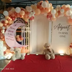 This "I love you to the moon and back" theme is perfect for a first birthday. We used a soft, neutral color palette for the balloon arch, a large moon-shaped prop, teddy bears, and a red carpet for a warm and loving celebration.