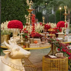 A prasad and offerings table from the Shiva-Parvati themed wedding. Every detail, including the golden Nandi statue and traditional brass lamps, was curated to align with the sacred and devotional atmosphere of the ceremony.