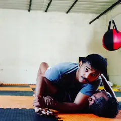 A close-up shot during a No-Gi sparring session. I'm working to secure a kimura grip from top side control, a high percentage submission lock.