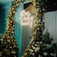 This neon sign, set against a circular arch of lush flowers, was the perfect centerpiece for the party. It instantly created a fun, high-energy vibe and served as a popular photo spot for guests.