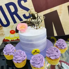 We create coordinated dessert tables for your events. This set for a bridal shower includes a central lavender ombre cake with a "Bride to Be" topper, perfectly matched with a half-dozen frosted cupcakes for guests to enjoy.