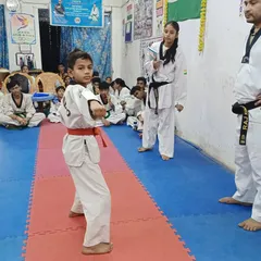 A student demonstrates a precise Poomsae (form) during the belt upgrading test. We test for both technical skill and discipline.