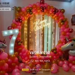 This 7th birthday unicorn party features a vibrant pink and gold balloon ring. The large light-up marquee number and unicorn foil balloons on each side make for a truly magical and celebratory setup.