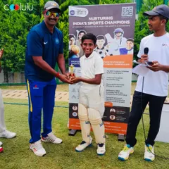 A young cricketer proudly receives a trophy for his outstanding performance. We make sure to recognize individual effort and achievement at our camps.