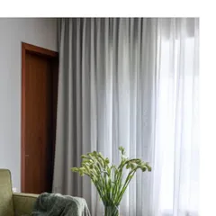 The simple elegance of a sheer curtain diffusing natural light. We use lighting, both natural and artificial, as a key material in our design palette to shape the mood of a space.