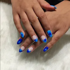 Starry-eyed for this blue design. I created this look with a negative space base, bold blue French tips, and star accents for a modern and graphic style.