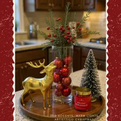 Red accents and warm lights are my go-to for Christmas. This setup on a wooden tray features a golden reindeer sculpture, a vase with red berries, and a holiday-scented candle for that perfect festive feel.