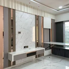 To maximize floor space in this Kandivali apartment, I designed a folding dining table that seamlessly integrates into the wall paneling and TV unit. When not in use, it folds away completely, demonstrating my approach to smart, space-saving furniture.