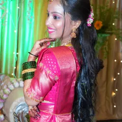 A candid portrait taken during a family event, highlighting the intricate hairstyle and jewelry. I look for these moments of quiet elegance amidst the celebration.