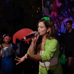 Engaging with the audience during a fun neon-themed party, making sure everyone is part of the action.