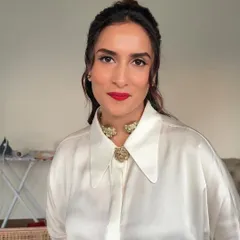 The front view of this classic glam look. The half-up hairstyle is paired with a sharp winged liner and a bold red lip for a powerful statement.