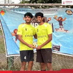 Two players from the winning football team receiving their trophy. We ensure that individual contributions are celebrated alongside team success.