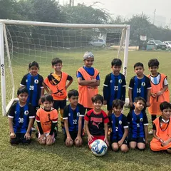 Our U8 team ready for action, lined up in front of the goal before their friendly match.