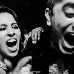 Pure, uninhibited joy! This close-up of guests laughing and shouting on the dance floor captures the soul of the party.