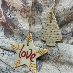 Another view of the 'Love' ornament set, showing the delicate line work and patterns.