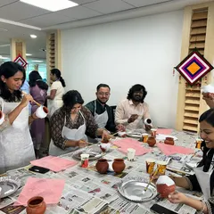 Everyone getting into the creative spirit, painting their pots with bright colors and unique designs. This is a fantastic hands-on activity for team bonding.