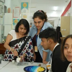 I'm demonstrating a resin pouring technique to participants from the Google team. My corporate workshops are fully guided to ensure everyone has a great time and creates something beautiful.