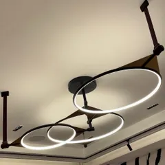 The Saturn Pendant Chandelier brings celestial elegance to this living area. Its intersecting rings of light create a sophisticated and contemporary statement, elevating the entire room's design.
