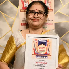 Ms. Smita Wagh proudly holding her Rhythmite Best Music Educator Award for Hindustani Classical Singing.