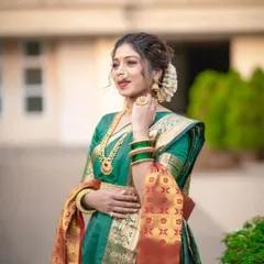 A close-up of the Nauvari look, highlighting the intricate details of the drape, the traditional jewelry, and the floral hair accessory (gajra). Every element works together to create a complete picture.