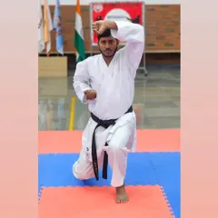 A strong stance is the root of all power in karate. Here I am demonstrating a fundamental pose, emphasizing the focus and stability that is central to my teaching.