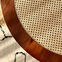 A close-up showing the edge of the coffee table, highlighting the quality of the wood finish and the clean joinery.