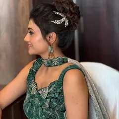 A classic, elegant updo is perfect for a reception or cocktail party. I crafted this textured messy bun to look effortlessly chic, finishing it with a delicate, leaf-inspired crystal accessory to catch the light beautifully.