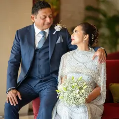 A beautiful portrait from a silver wedding anniversary celebration. Their comfortable embrace and happy expressions show a love that has stood the test of time.