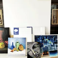 Another view of my art collection and supplies. This is my creative sanctuary, filled with oil paints, acrylics, brushes, and original artworks.
