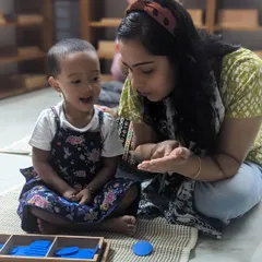 As a guide, your role is not to instruct, but to connect. Here, a teacher shares a moment of discovery with a child using geometric shape insets. You will learn how to facilitate these joyful interactions that spark a child's natural curiosity and love for learning.