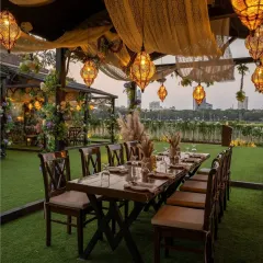 I designed this intimate alfresco dinner setting for a rustic yet romantic feel. The long wooden table, warm Moroccan-style lanterns, and soft fabric draping create a cozy and inviting atmosphere for a special milestone celebration.