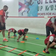 Our coaches are right there on the floor with the kids, providing hands-on guidance. We focus on teaching proper form and technique for foundational exercises like agility ladder drills to build a strong athletic base safely.
