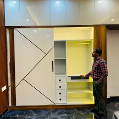 Here you can see the internal layout of the sliding wardrobe. I've included a mix of hanging space, drawers, and open shelves to organize everything from suits to small accessories.