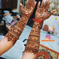 A full view of the design from the previous image, showing both hands. The artwork includes the ring ceremony, doli, and other auspicious symbols like the kalash and lotus flowers, all tied together with intricate patterns.