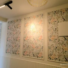 Another angle of the floral wainscoting project, showing how the panels run along the length of the wall. The lower half of the wall features simple vertical paneling for a complete look.