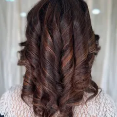 A perfect example of classic, voluminous curls on medium-length hair. This style adds glamour and sophistication and is perfect for any special occasion.
