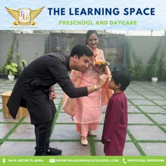 A father joins in our festive welcome, applying a tilak to his child. I love involving parents in our celebrations, creating a strong community bond.