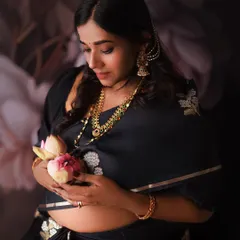 We wanted to create something truly special and symbolic for this shoot. The lotus flower represents purity and new beginnings, gently held over her belly.