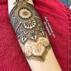 A beautiful arm piece that combines a central mandala with flowing paisley and floral patterns.