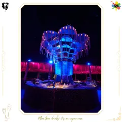 A grand, circular bar designed for a large-scale wedding. The illuminated central structure serves as a stunning focal point, ensuring efficient service while making a powerful design statement.