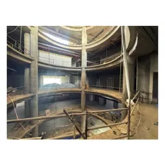 This construction photo shows the scale of the atrium at Sant Nirankari Hospital. The space is designed to anchor the hospital's spatial organization, seamlessly integrating movement, light, and visibility.