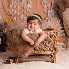 Another shot of this sweet girl with the most heartwarming smile. The neutral tones and textures of the boho setup really make her happy expression shine.