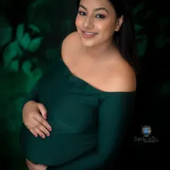 I love playing with different moods in my studio. For this portrait, we chose a deep emerald green off the shoulder dress and a dark, leafy backdrop to create a rich, artistic image that feels both intimate and dramatic.
