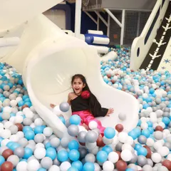 The pure joy of sliding into a sea of colorful balls! Our giant ball pit and slide is a favorite, providing endless laughter and picture perfect moments.