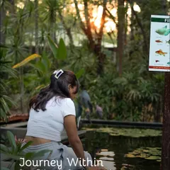 A journey within. A guest takes a quiet moment by a pond, stepping off the path to find something new.