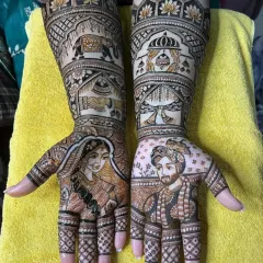A classic bride and groom portrait is always a beautiful choice. I focus on getting the likeness right, with fine lines and shading to create a realistic 3D effect. Here, the portraits on each palm are complemented by traditional symbols like elephants and temple architecture.